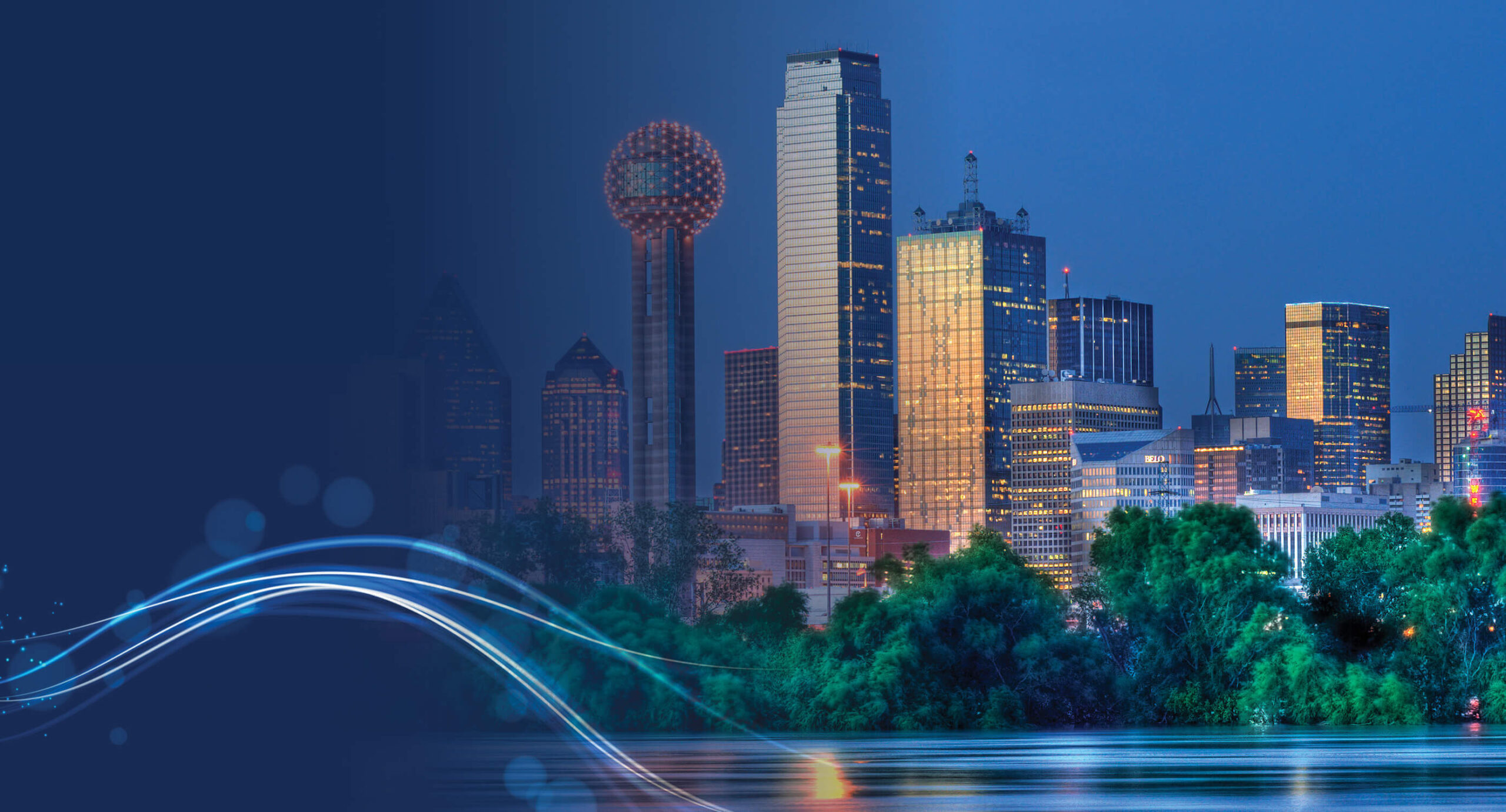 Nighttime cityscape with illuminated skyscrapers and the Reunion Tower, overlaid with flowing blue light streaks, symbolizing innovation and connectivity.